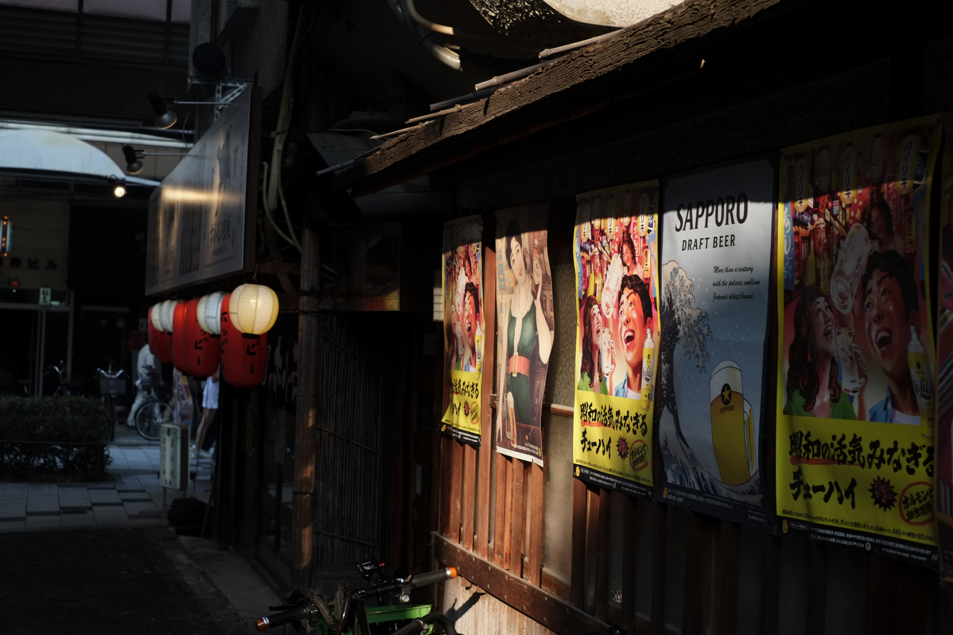 Lanterns and posters outside a tiny izakaya bar